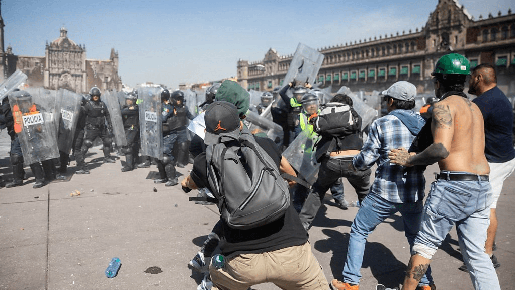 Thousands protest against government in Mexico as clashes leave 120 injured